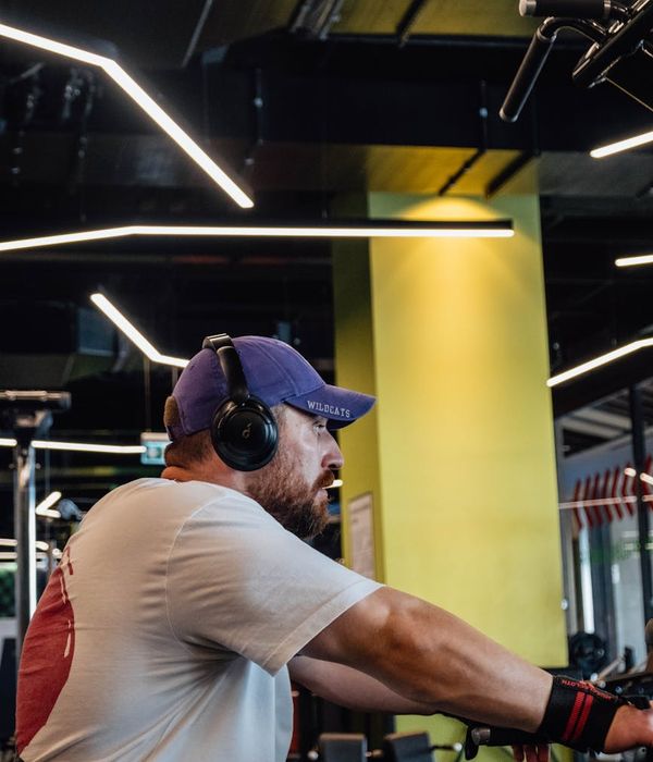 Man performing strength exercises in a modern gym setting
